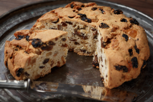 Pandolce Genovese with a slice cut out of it - filled with dried fruit