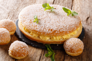 Delicious large Tarte Tropezienne in the middle with smaller tarts around