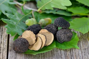 Black truffles on leaves with four slices.