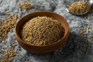 Wooden bowl filled with Ajwain seeds