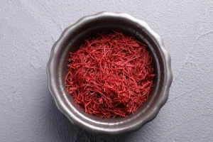 Silver bowl filled with bright red saffron.