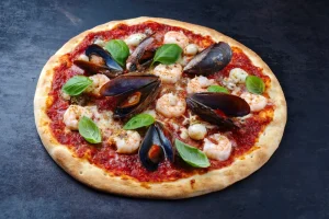 Frutti di Mare pizza qith mussels, prawns and basil.