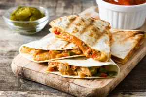 Quesadilla on chopping board.
