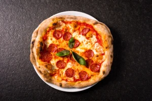 Spicy diavola pizza with pepperoni and basil.